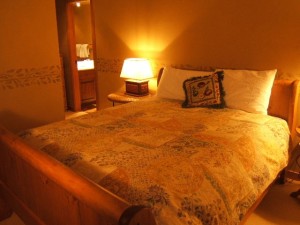 Beautiful bedroom with queen sleigh bed and ensuite bathroom with heated tile floor