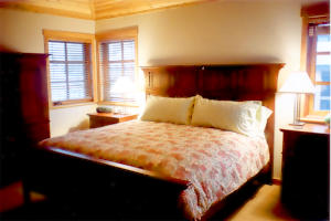 Spacious master bedroom with king size bed, gas fireplace, walk in closet and huge ensuite bathroom with heated tile floor